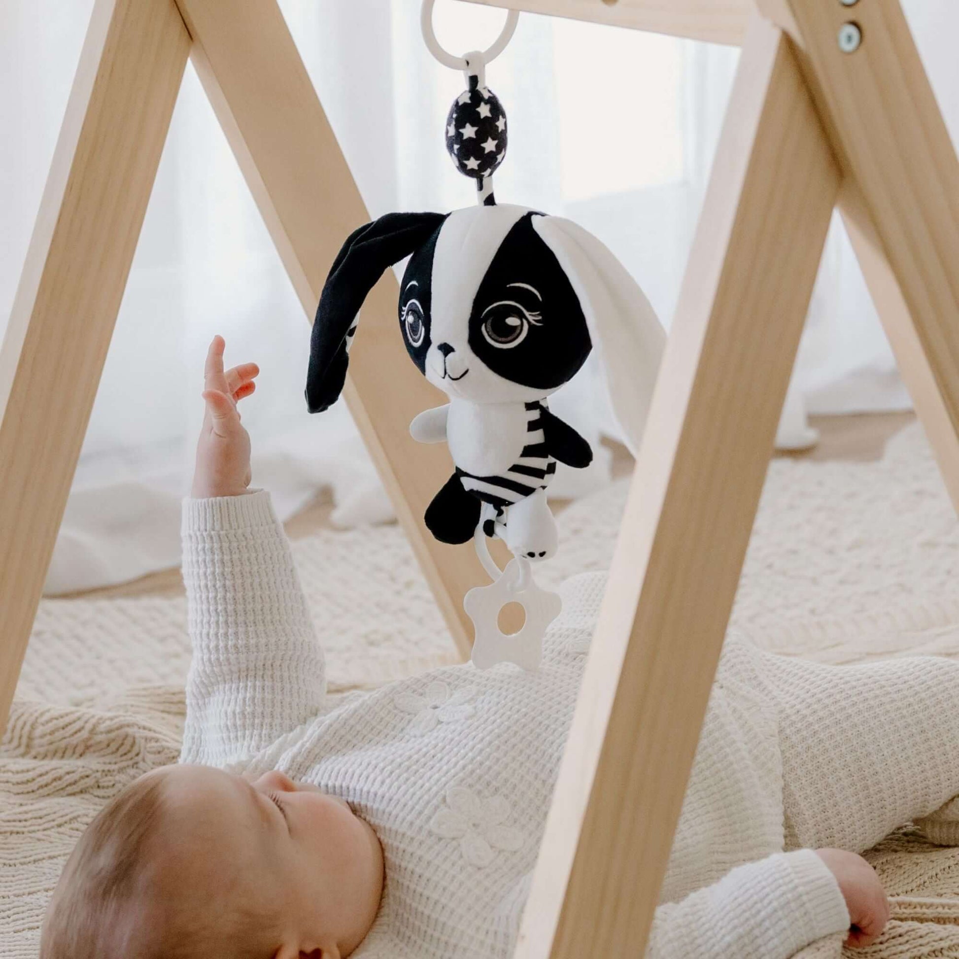 Billie the Bunny hanging baby toy attached to wooden baby play gym for sensory development